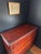 Oxblood painted pine chest of drawers with lovely patina and charming antique metal pulls. Drawers feature pin and cove...