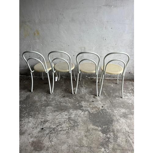 Introduction minimalist vintage chairs with a sculptural tubular metal frame and woven-look plastic seats. A light,...