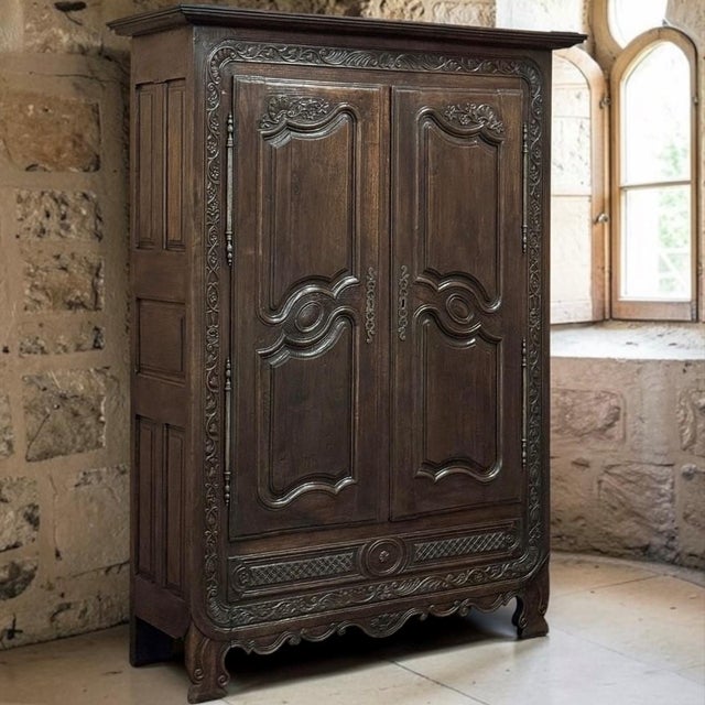 Exceptional 18th century Country French Normandy armoire hand crafted from solid oak, distinguished by unusually elaborate...