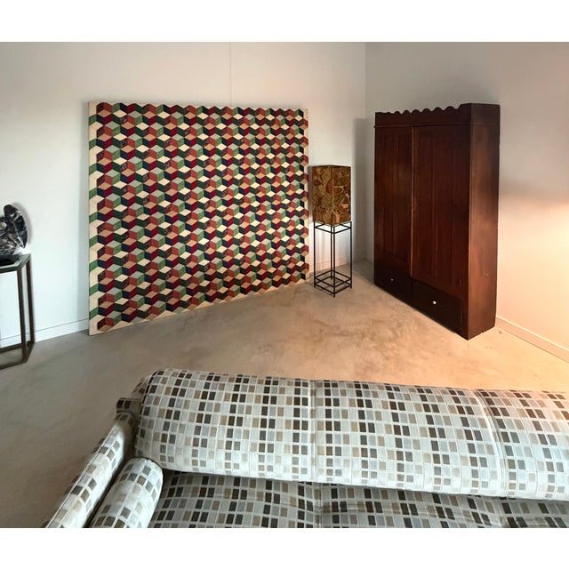 A framed quilt created with cotton, hand-stitched textiles from the 1980s in a tumbling block pattern. Lovely textures and...