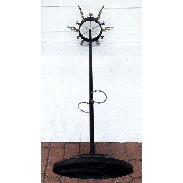 An elegant and highly decorative freestanding vintage coat rack, Jacques Adnet, France, 1950s, with a distinctive...