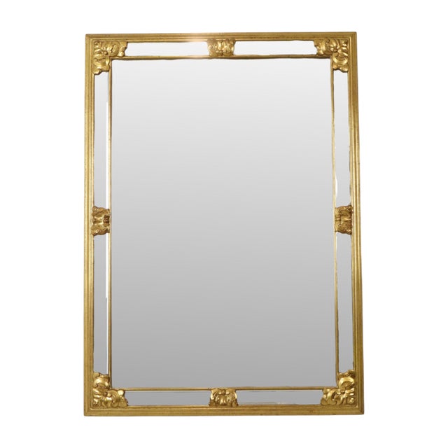Large vintage rectangular deknudt mirror featuring beveled side panels and gold-tone acanthus accents throughout; a 1970s...