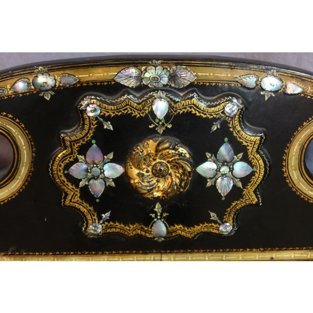 Large Napoleon III period sofa in ebonized wood and caning. This sofa features elegant decoration with gilt ornamentation...
