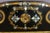 Large Napoleon III period sofa in ebonized wood and caning. This sofa features elegant decoration with gilt ornamentation...