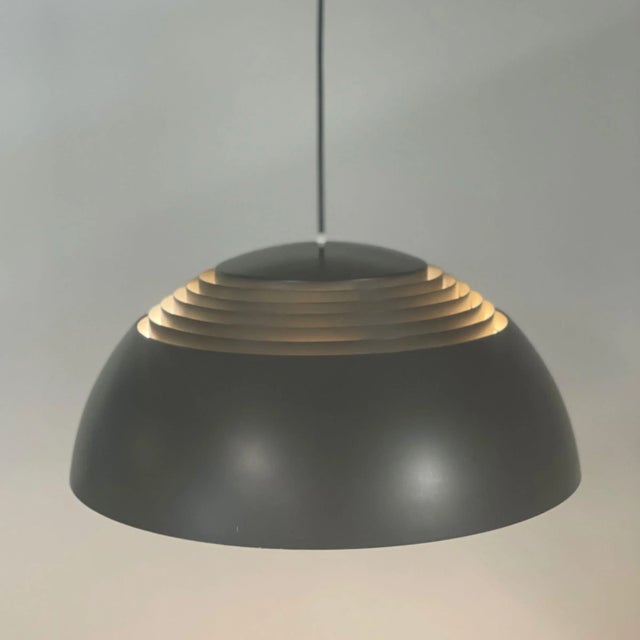 Brown aj pendant designed in 1957 by arne jacobsen for the sas royal hotel in copenhagen and manufactured in the 1980s by...
