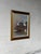 This scenic landscape painting depicts a tranquil winter canal setting with snow-capped architecture and a moored boat....