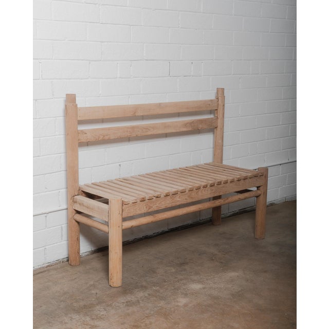This rustic handcrafted wooden bench features a beautifully simple slatted seat and a sturdy backrest, exuding an organic,...
