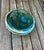 Substantial emerald green cased art glass bowl attributed to Murano, Italy. This striking decorative piece features deep...