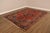High Quality Antique Heriz Hand Tied Oriental Rug Featuring A Bold Geometric Medallion Set Within A Deep Red Field. The...