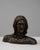 This 20th Century French plaster bust depicts a stoic male figure with strong, angular features and a contemplative...