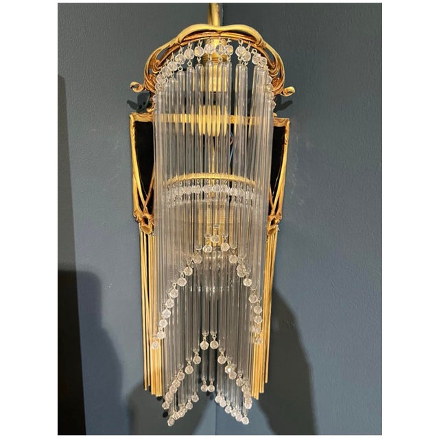 Art Nouveau style wall lamp in bronze and glass paste. In the Hector Guimard style, this so-called butterfly lamp is...