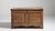 A substantial carved oak trunk reflecting traditional storage forms used before the widespread use of built-in cabinetry....