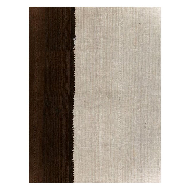 A vintage Turkish tribal flatweave Kilim accent rug handmade during the mid-20th century in shades of brown and cream....