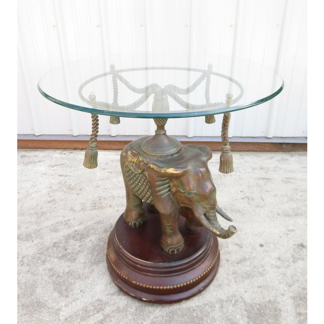 Vintage bronze elephant Maitland-Smith round glass top side table. This piece is solid, sturdy, and completely functional....