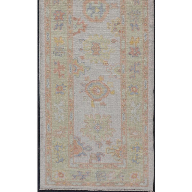 Measures: 2'11 x 13'3 Turkish Oushak Runner in Ivory with Soft Green, Gold, and Coral 2'11 x 13'3. Keivan Woven Arts. rug...