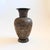 A vintage brass vase with an intricate etched floral design with peacocks to the surface. Black finish with the etched...