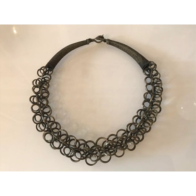 Sculptural metal body adornment handmade most exquisitely with one continuing twisted metal band creating the final look...