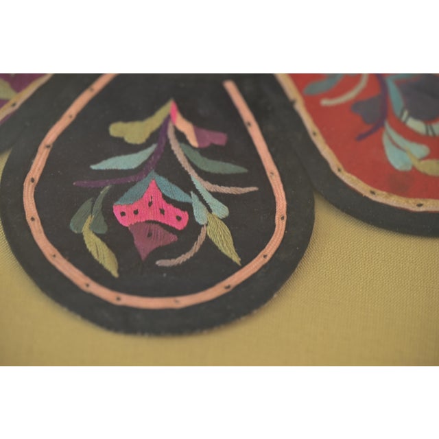 This Chinese embroidered silk child’s collar was used for festivals. Each of the six lobes features a flower or fruit...