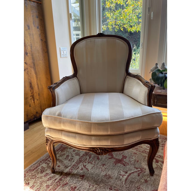 Beautiful set of 2 Louis XV style Bergère armchairs, featuring gracefully carved wooden walnut frame, shaped cabriole...