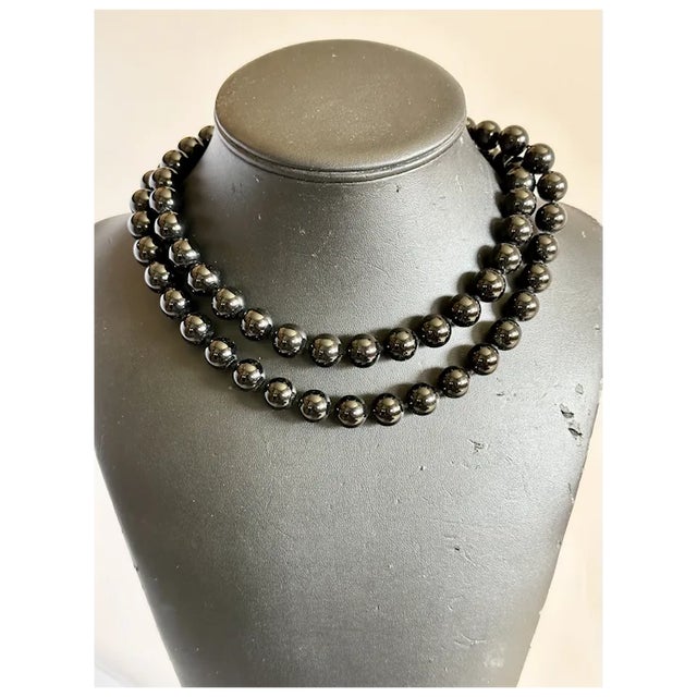 Stunning 34" beaded onyx necklace. Each bead is the same size measuring a bold 12mm, with knots in between each bead for...
