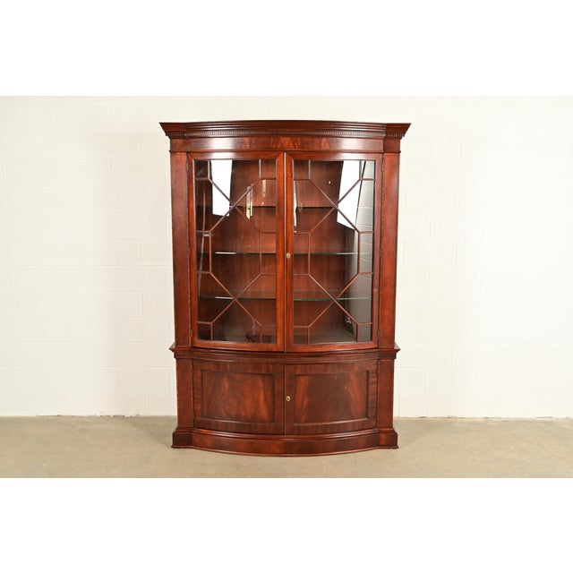 A gorgeous Georgian or Chippendale style lighted breakfront bookcase or dining cabinet By Baker Furniture, "Historic...