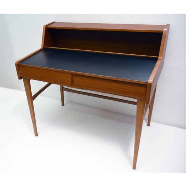 1960s Danish Desk. Made of wood with two drawers at the front, a scratch-resistant black top and a storage compartment....