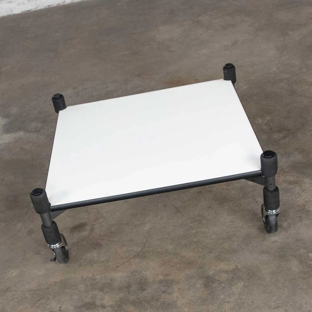 Stylish post-modern white laminate rolling low coffee table or end table on casters in the style of Brian Kane’s rubber...