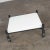 Stylish post-modern white laminate rolling low coffee table or end table on casters in the style of Brian Kane’s rubber...