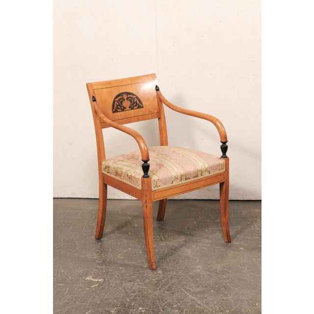 A pair of birch wood Danish armchairs, with upholstered seats, from the mid 19th century. This antique pair of accent...