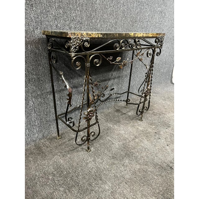 Late 19th C. Oscar Bach style marble and iron console table with ornate floral base.