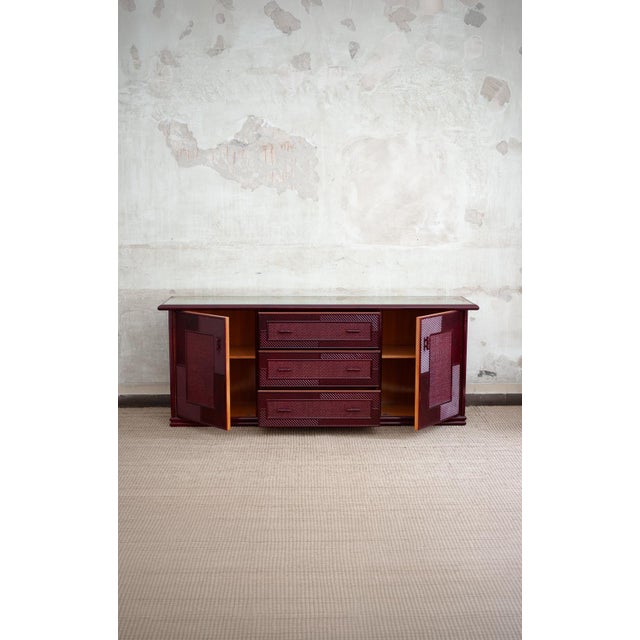 Lacquered Bamboo Sideboard – 1980s Made of red lacquered bamboo with smoked glass top and rush bindings. Decorated with...