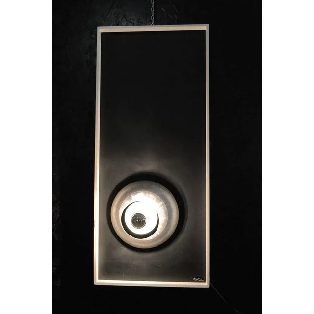 - Lighting panel in lacquered wood with aluminumum lighting sculpture - Produced in Italy in the 1970s - Signed with title...
