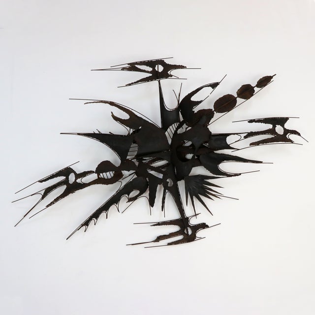 An extraordinary kinetic and Brutalist wall sculpture in torch-cut and welded wrought iron, attributed to Italian designer...