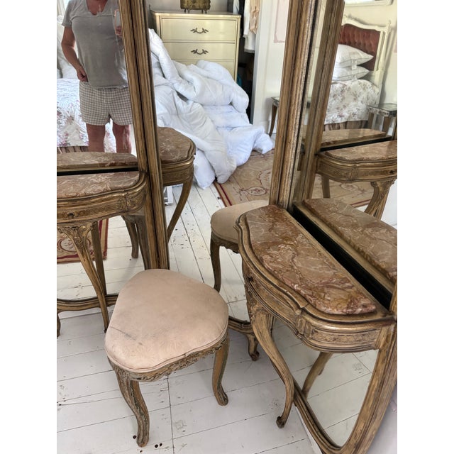 French Louis XV style elegant 3 part vanity with ornate carved crest and aged gilt finish. Has gracefully shaped hinged...