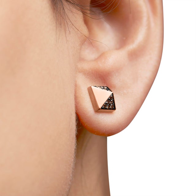 Immerse yourself in the subtle opulence of these 14K rose gold earrings, masterfully crafted into a mesmerizing pyramid...