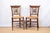 A pair of antique chairs with rush seats and hand painted splats, late 19th century, French. Splats feature two scenes...
