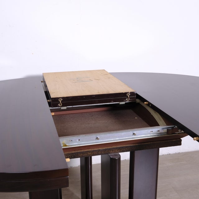 The table features a solid structure, with elegant metal details along the base. It opens easily and is extendable....