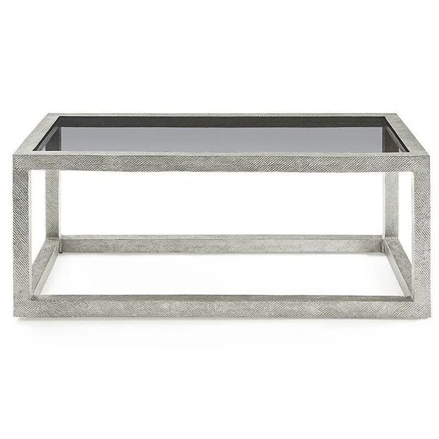 A lovely low table with a metal textured frame that is fitted with an inset tinted glass top. Care Instructions: Wipe with...