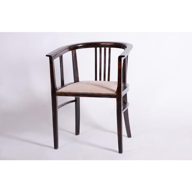 This elegant Art Deco armchair comes from Czechoslovakia from the first half of the 20th century. It is made of solid...