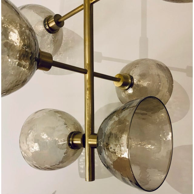 Stylish Arteriors Modern Brass Finished Norwich Chandelier, Smokey textured glass shades, showroom floor sample