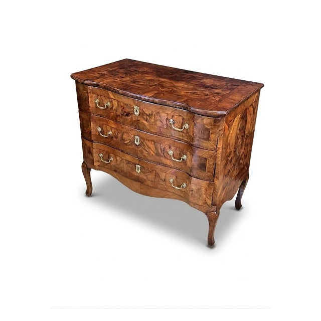 this exquisite 18th Century European (likely Northern Italian) Rococo chest of drawers featuring dramatic wood figuring;...