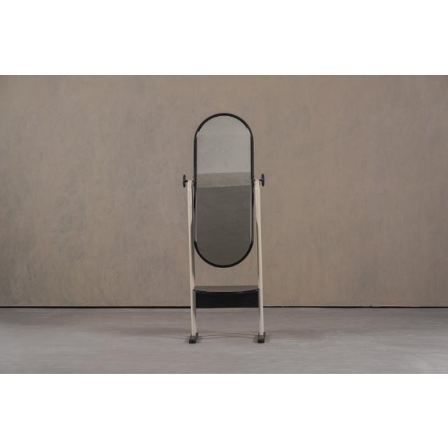 This Postmodern floor mirror was produced in Italy during the 1980's and reflects the bold and playful design approach of...