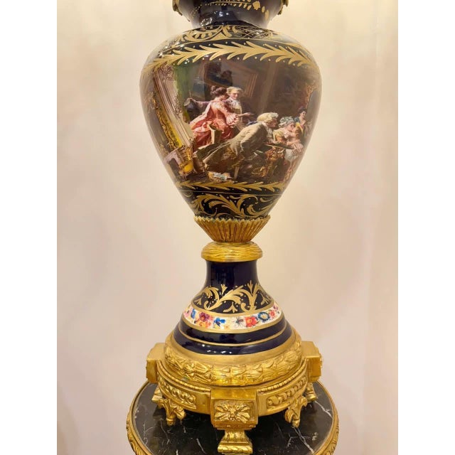 Description: An extraordinary and imposing pair of antique Sevres-style porcelain vases, each mounted on its own...
