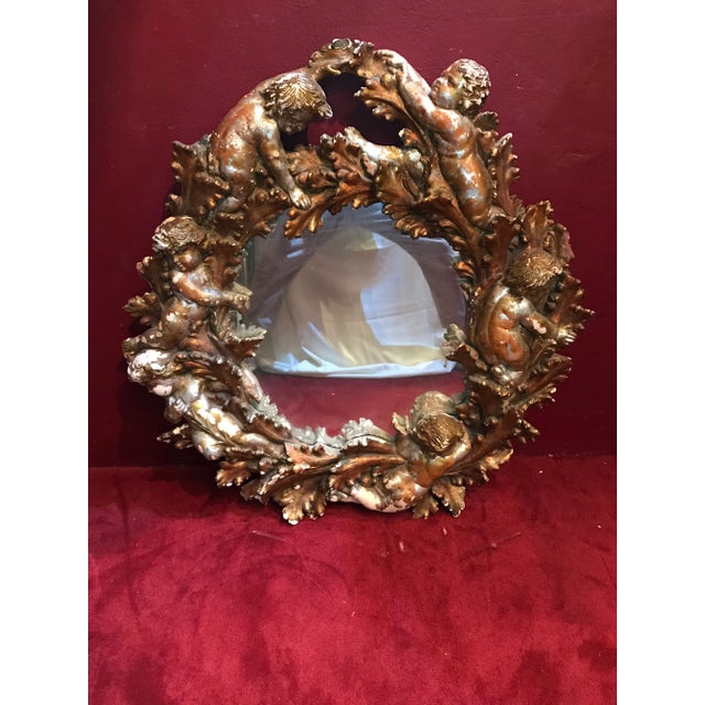 Very heavy plaster or terra-cotta angel or cherubs mirror with a gold finish with distress please see photos for specifics
