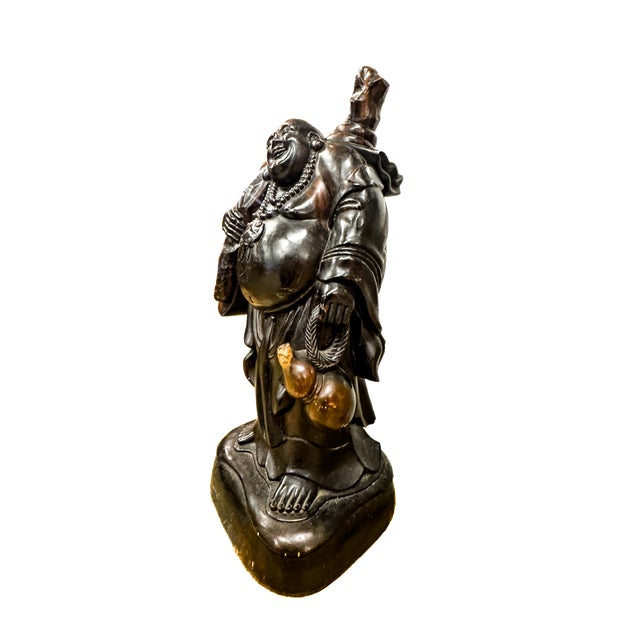 A vintage, hand-carved rosewood statue of Hotei, also known as the Laughing Buddha. This impressive object arrived...