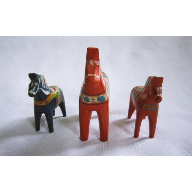 Set of three vintage Dala Wood Horses from Sweden. The larger horse measures 4"H x 4"L x 1.25 'W and the two smaller ones...