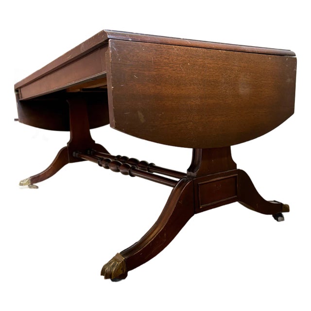 Vintage Dark Wood Coffee Table With Brass Claw Wheels For Sale