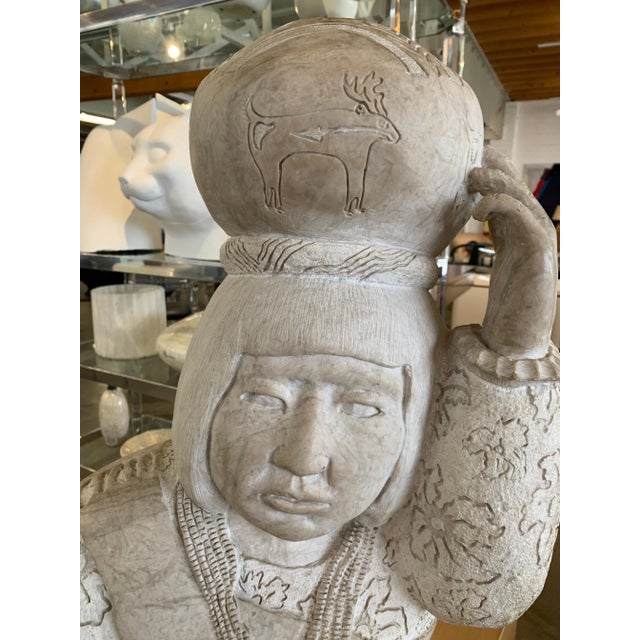 A large and impressive sculpture of an American Inuit with a basket on his head by Doug Hyde. This heavy piece is signed...