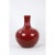 This vase is glazed in a red that allows subtle relief detail to be seen. Has some damage, big crack .
