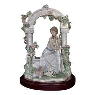Lladró Tranquility (Model #06677) Porcelain Figurine, Featuring a Seated Woman Under a Floral Arbor For Sale